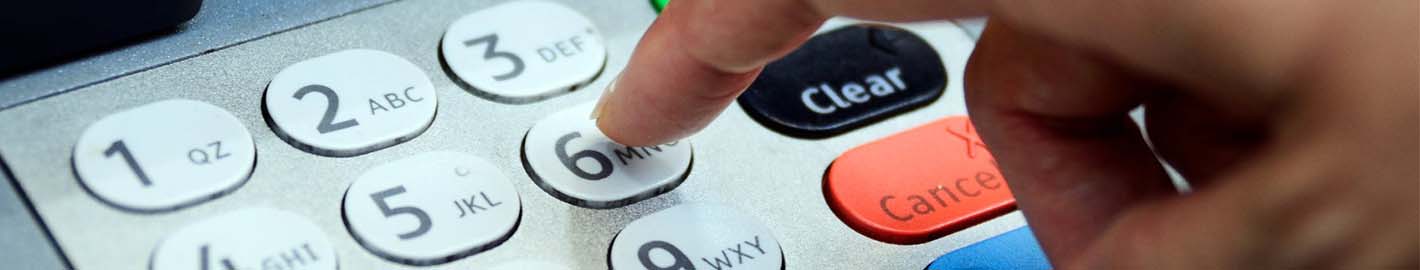 image of a person's finger typing keys on the key pad. for example what you would do to enter your password for ATM access to your account.
